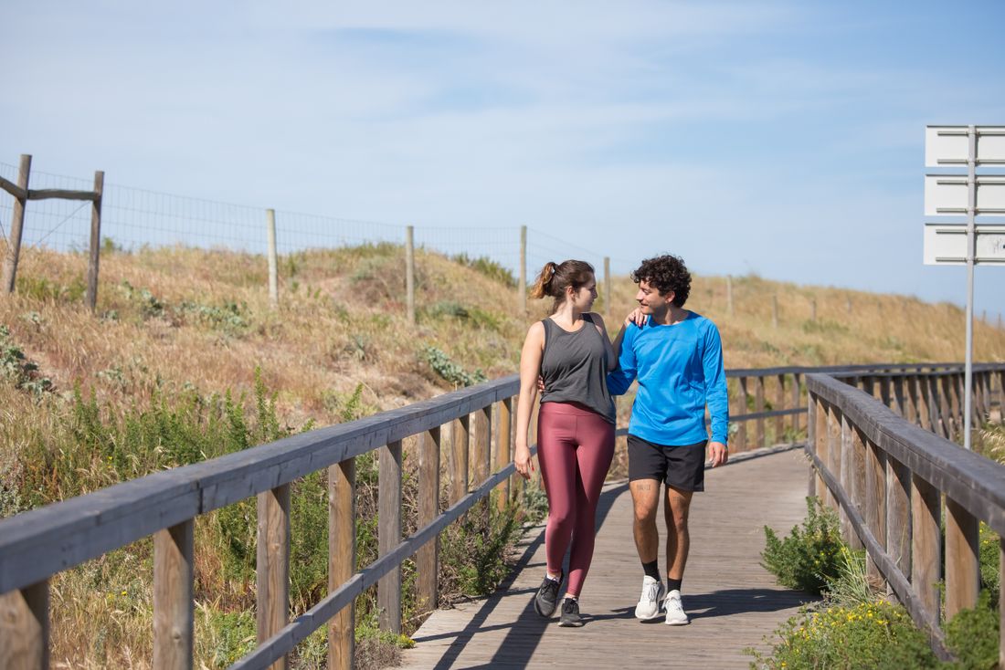 A man and woman enjoying a walk together on an outdoor path